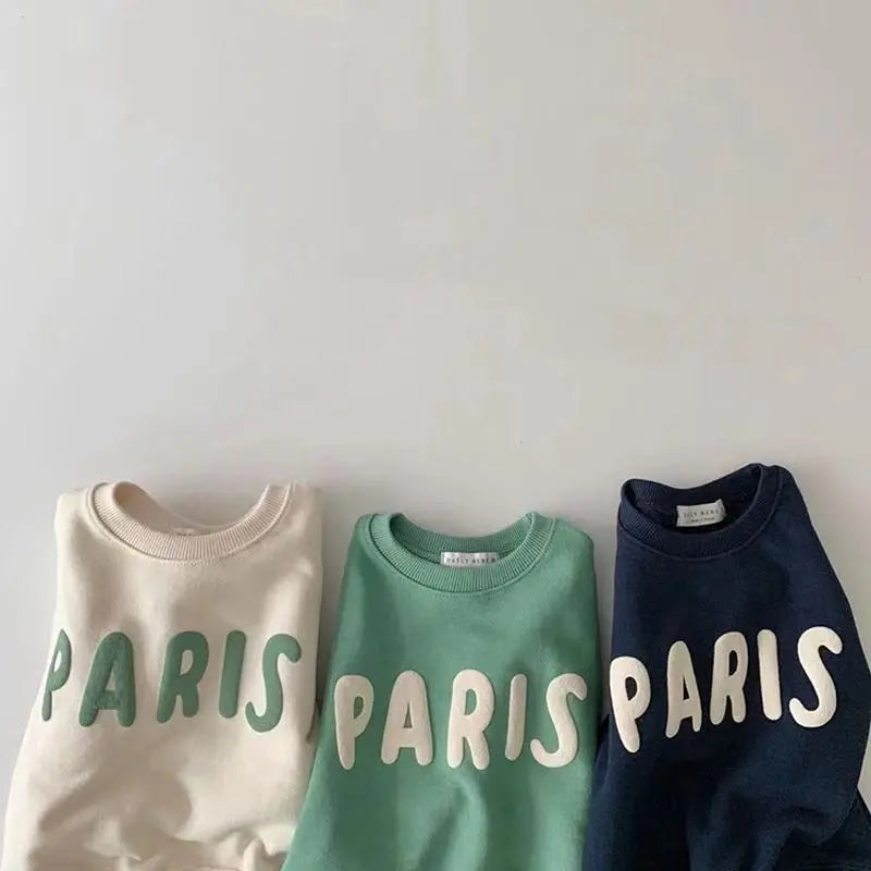 Paris Sweatshirt Groen Beige Donkerblauw Opgevouwen Naast Elkaar